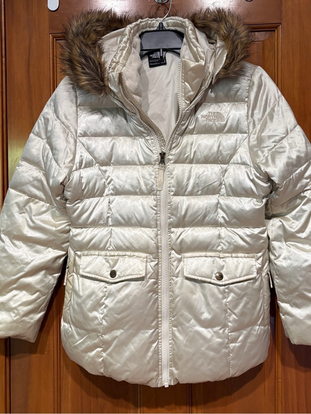 The North Face Girls champagne-colored puffer jacket